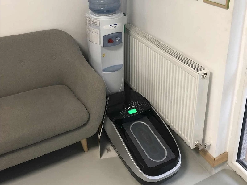 QUEN shoe cover dispenser in a reception waiting area