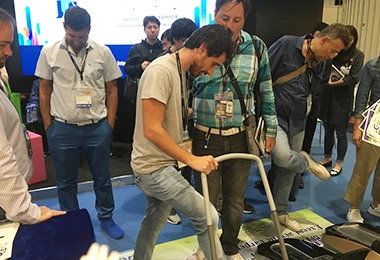International visitors testing QUEN shoe cover machine on-site