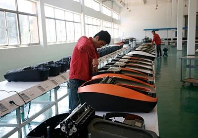 QUEN production workers on the shoe cover machine line